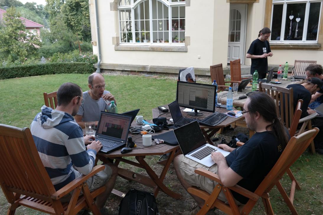 team working on laptops outdoors